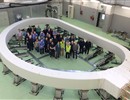 Representatives of F4E, ITER IO and F4E contractors standing inside the first ITER Toroidal Field coil  winding pack- one of the biggest magnets to be manufactured.