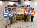 Members of the teams from F4E, ITER IO, CNIM and Douce Hydro in front of the Pre-Compression Rings tooling, CNIM, La Seyne-sur-Mer, France.