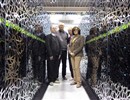 CEA-F4E CSC team standing between a section of the “Helios” supercomputer: from left to right, Jacques David, François Robin, Jacques Noé (CEA) and Susana Clement Lorenzo (F4E).